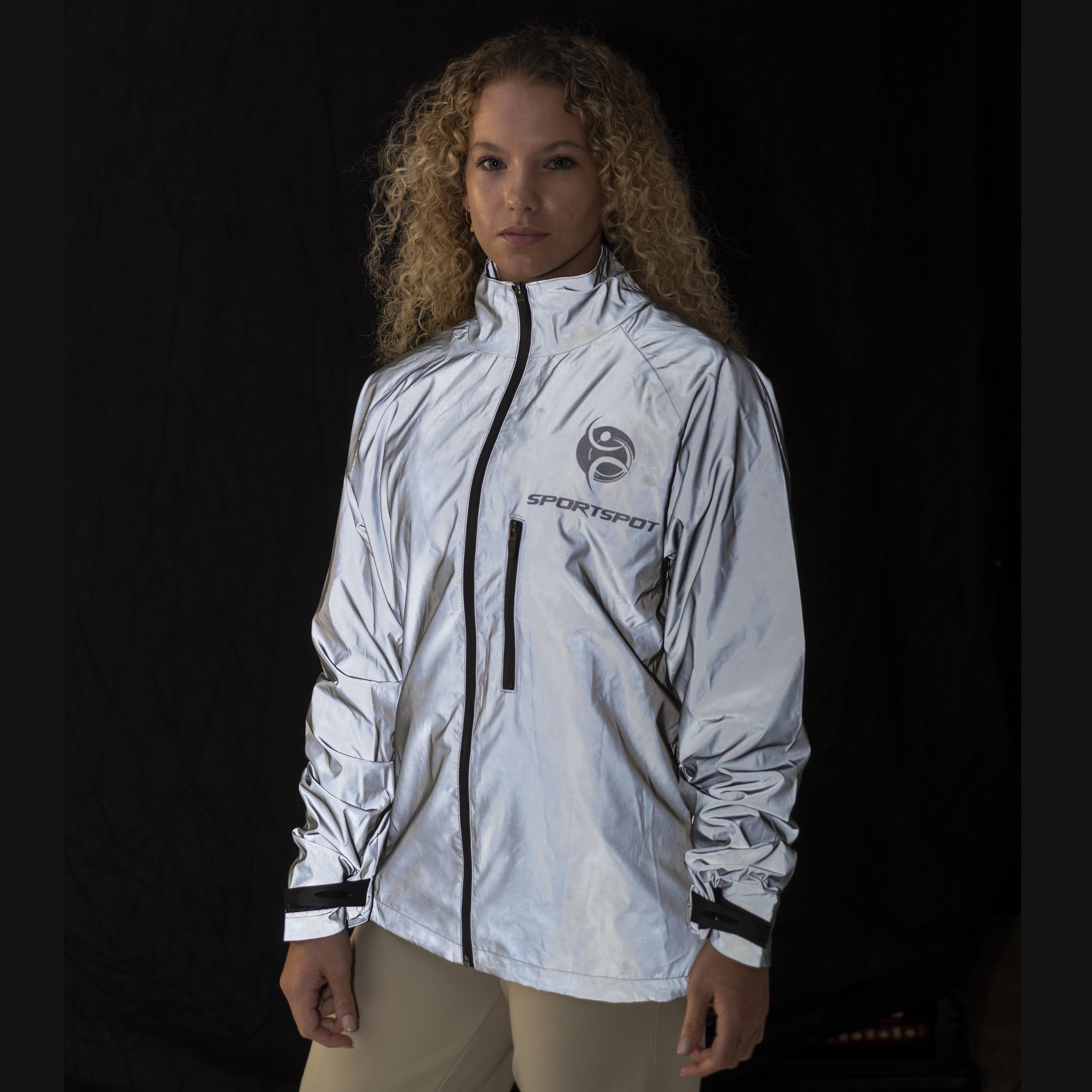 Woman wearing Kallie Reflective Cycling Jacket – reflective silver visibility during night ride